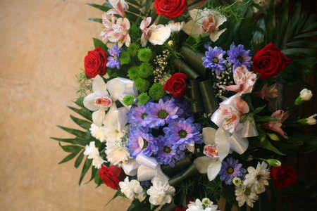 Big bouquet of colorful different flowers top view against orange stone backgroundの写真素材