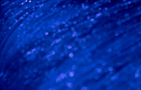 Shiny blue festive tissue blurred pattern. Abstract glowing backdrop.の写真素材