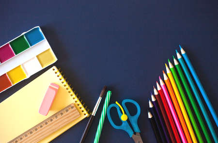 School supplies on dark blue background. Back to school concept. Flat lay, copy space.の写真素材