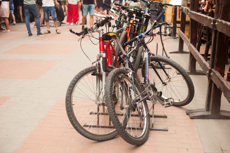 Bicycle parking lot in the city street. Blurred people behind.