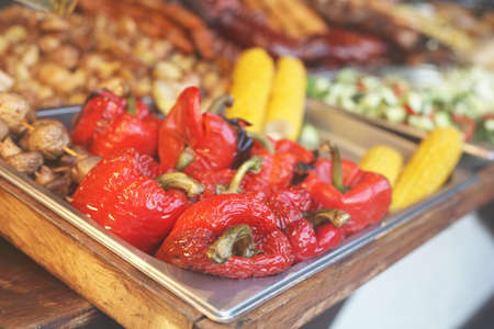 Street food festival, delicious grilled red peppers and other vegetables. Selective focus.の写真素材