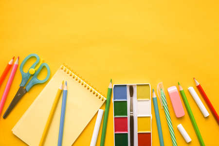 Back to school. Items for the school against yellow background. Flat lay.の写真素材