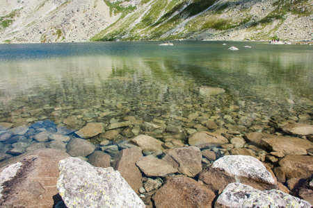 View of beautiful lake with clean water and rocks in the mountainsの写真素材