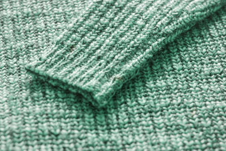 Trendy neo mint tissue texture background. Pattern of clothes as fashion trend concept. Knitted background. Warm tissue clothes texture. Close up of sweater.の写真素材
