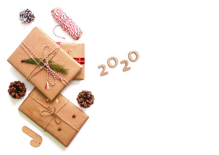Holiday Christmas gift boxes decorated with red ribbons and pine cones, 2020 new year numbers...