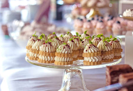 Dessert table for a party. Desserts, cupcakes, candies and flowers. Outdoorの写真素材