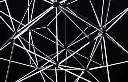 Abstract geometric black background made of light tubes. Black and white colors.の写真素材