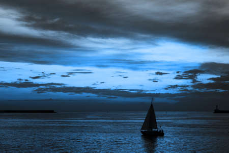 Dramatic sky and sunset picturesque scenery. Cloudy sky and sea landscape. Trendy blue color. 2020の写真素材