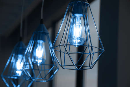Minimalistic stylish lamps decorated in a modern style. Selective focus. Classic blue color of 2020 year. Trend.の写真素材