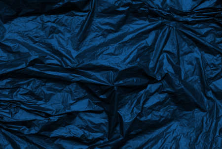 Classic blue crumpled metallic texture synthetic background. Abstract pattern for design. Trend of 2020 colorの写真素材