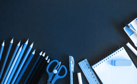 School or office stuff monchrome trendy classic blue toning. Pencils and notepad background, flat lay, top viewの写真素材