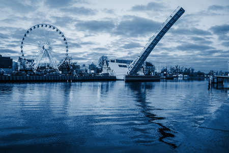 Evening view of the city river embankment, trendy monochrome classic blue toning, old European city of Gdanskの写真素材