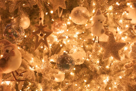 Christmas tree decoration close up, golden sparkling bokeh background, wooden toyの写真素材