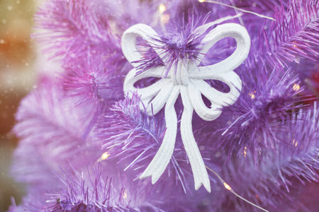 Close up of Christmas tree with lights and decorations, winter festive background, details