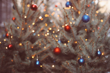 Close up of Christmas tree with lights and decorations, winter festive background, details