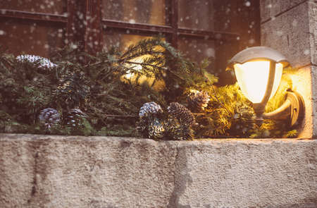 Christmas wreath, decorated window on door in winter made of tree branches, decor, balls and ribbons, holiday design ideaの写真素材