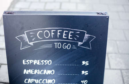 Black outdoor sign coffee to go on the street, menu, outsideの写真素材