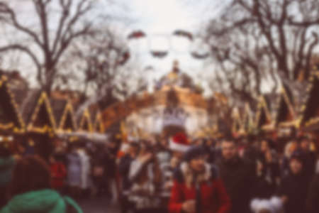 Defocused background of the European Christmas market. Blurred crowd and bokeh of festive lights, day timeの写真素材
