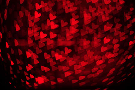Overlay blurry background of red hearts bokeh, for Valentine's or holidays card designの写真素材
