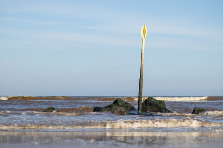 A post standing tall along the Dutch shoreの写真素材