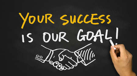 your success is our goal handwritten on blackboardの写真素材