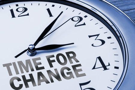 time for change concept on wall clock
