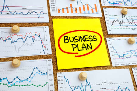 business plan concept handwritten on a yellow noteの写真素材