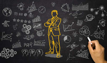business elements and businessman hand drawn on blackboardの写真素材