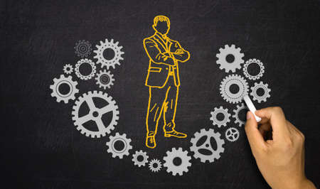 businessman and gears hand drawn on blackboardの写真素材