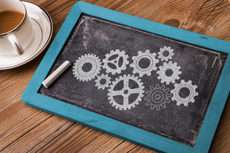 business concept: gears hand drawn on chalkboardの写真素材