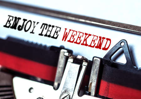 enjoy the weekend typed on white paper with old typewriterの写真素材