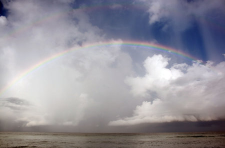 Colorful rainbow over ocean after storm