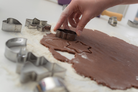 Cutting chocolate dough in kitchenの写真素材