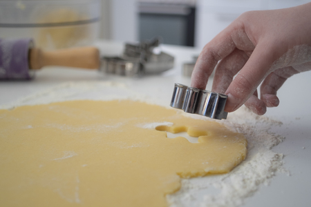 Hands cutting cookie doughの写真素材