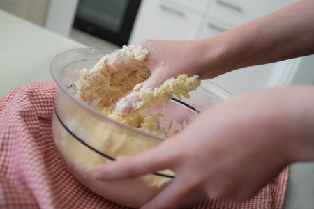 Kneading cookie dough in a bowlの写真素材