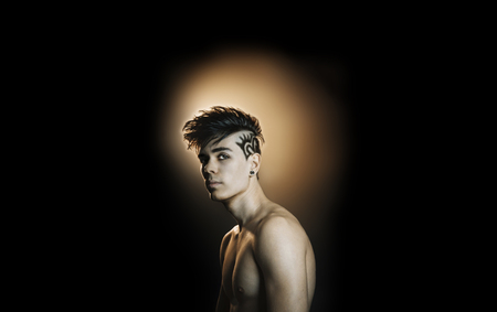 Model man with a hairstyle on a black backgroundの写真素材