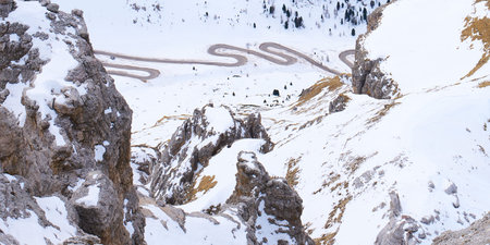 Aerial view of winding mountain road near Passo Pordoi, Italy
