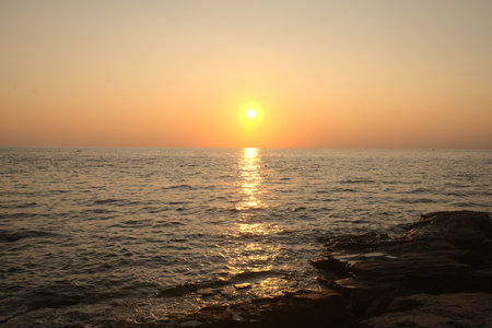 Beautiful sunset at the sea. The sun sets over the sea.の写真素材