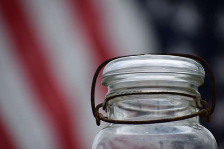 A wire bail jar with an American flag backgroundの写真素材