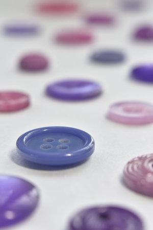 purple sewing buttons on whiteの写真素材