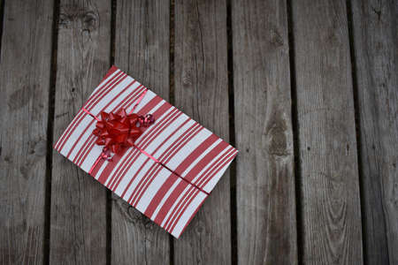 a red and white gift on wood slatsの写真素材