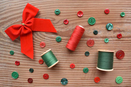 Chrismas bow, thread, and sewing buttonsの写真素材