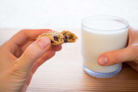 holding a cooking and glass of milkの写真素材