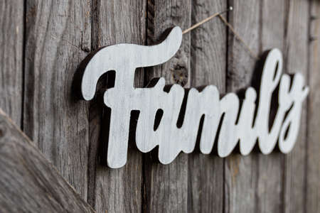 a wooden family sign on old barn boardの写真素材