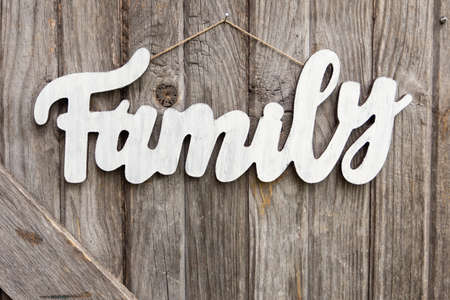 a wooden family sign on old barn boardの写真素材