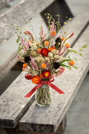 an arrangement of dried flowers on a benchの写真素材