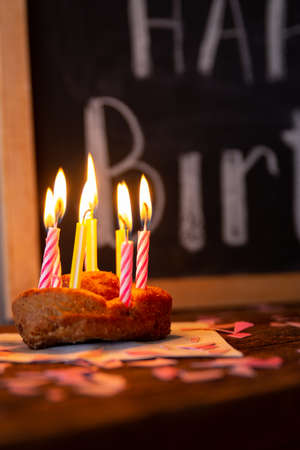happy birthday chalkboard sign with a cake and candlesの写真素材