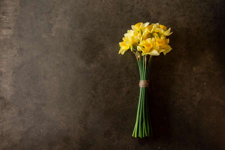 a boquet of yellow daffodil blooms on chalkboardの写真素材