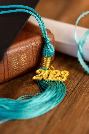 a 2023 graduation tassel on a bible with a capの写真素材