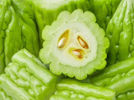 chinese bitter gourd green mature background a closeup texture of better melon fruit or rough-skinned vegetable for  boiled soup healthy food ingredient and medicinal herbの写真素材